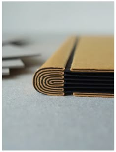 a stack of black and yellow books sitting on top of a white table next to each other