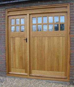 a wooden garage door is shown in front of a brick wall with windows on each side