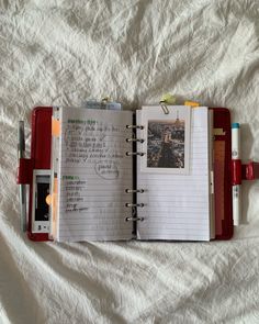 an open notebook on top of a bed