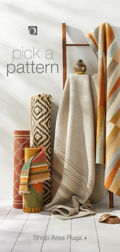 towels and rugs are arranged on the floor in front of a white wall with text pick a pattern shop area rugs