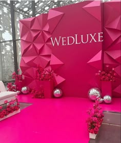 the entrance to wedluxe is decorated with pink flowers