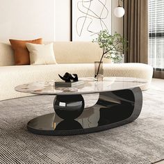 a living room with a couch, coffee table and vase on the floor in front of it