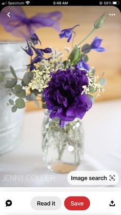 a vase filled with purple flowers on top of a table