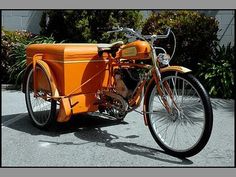 an orange motorcycle parked next to a building