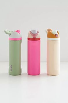 three different types of thermos are lined up in a row on a white surface