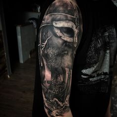 a man with a full sleeve tattoo on his arm