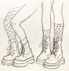 the legs and feet of two people wearing boots with laces on them, standing next to each other