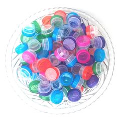 a bowl filled with lots of colorful plastic cups