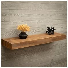 a wooden shelf with two vases on it