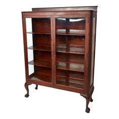 an old wooden bookcase with glass doors