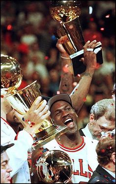 the chicago bulls celebrate with their championship trophies