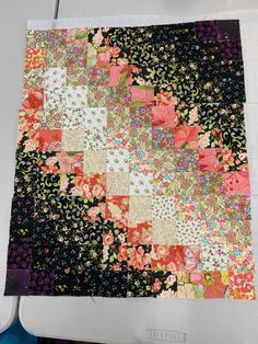 a piece of fabric that has been made into a patchwork quilt with flowers on it