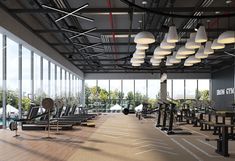 an empty gym with rows of treadmills and large windows looking out onto the pool