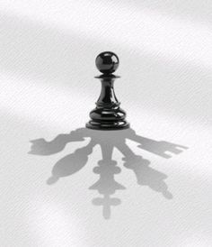 the shadow of a chess piece on a white surface