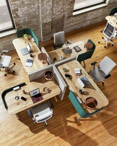 an overhead view of two tables with chairs and laptops on them in a living room