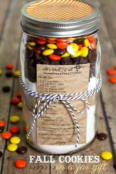 a mason jar filled with candy corn and chocolate chip cookies for halloween or any other celebration