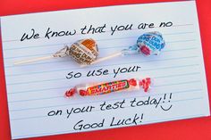 two candy lollipops are sitting on top of a piece of lined paper that says, we know that you are no so use your on your test today good luck