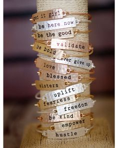 a stack of bracelets sitting on top of a wooden table