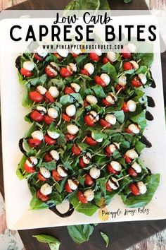 a white plate topped with spinach covered in cheese and tomato bites on top of lettuce