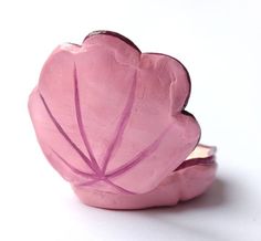 a pink flower shaped object sitting on top of a white table