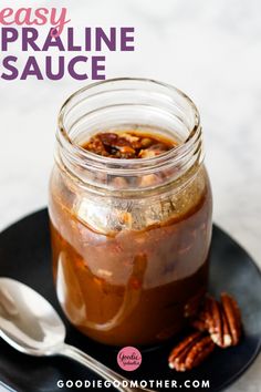 a glass jar filled with food sitting on top of a black plate