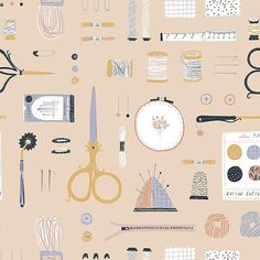 an assortment of sewing supplies on a pink background