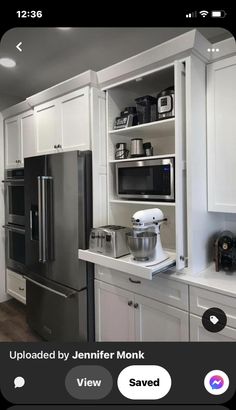 a kitchen with white cabinets and stainless steel appliances on the counter top, along with an instructive home furniture simple refrigerator