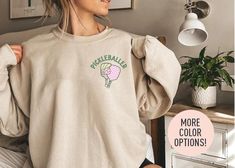 This Pickleballer Crewneck is the perfect birthday gift or Christmas gift for all women! All of our sweatshirts are made with the highest quality materials and are super soft and cozy! 💚 HOW TO ORDER 💚 1. Check our photos for sizing and color options. 📏 2. Choose your quantity.  Feel free to add as many shirts as you wish! ✨ 3. Select your size and color from the drop-down menus. ✨ 4. Click "ADD TO CART" to add the shirt to your virtual cart. 🛒 5. Click "PROCEED TO CHECKOUT" to purchase your shirt. 🛒 6. Your shirt is now off to production!  We will process your order and your shirt will be ready for shipment in 1-4 days! 🎁 📏 SHIRT SIZING All of our shirts come in a variety of colors and many different sizes! ✨ SHIRT INFORMATION + MATERIAL Our unisex crewnecks fit both men and women Perfect Birthday Gift, Perfect Birthday, Pickleball, Cut And Style, Crewneck Sweatshirt, Color Options, Ribbed Knit, Favorite Outfit, Birthday Gift