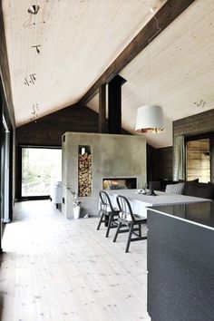 the interior of a modern house with wood floors and white walls is featured in this magazine