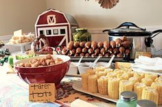 corn on the cob and other foods are sitting on a table