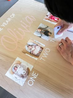 a person using a computer mouse on top of a wooden table with pictures and words