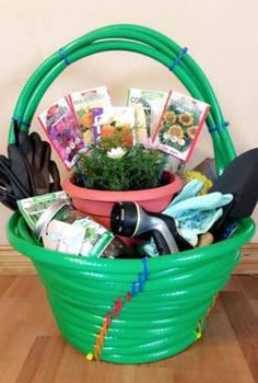 a green basket filled with gardening items on top of a wooden floor