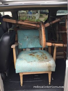 an old chair sitting in the back of a van