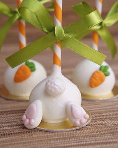 some white chocolates with green bows and carrots on them