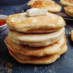 stack of pancakes with marshmallows on top and syrup in the back ground