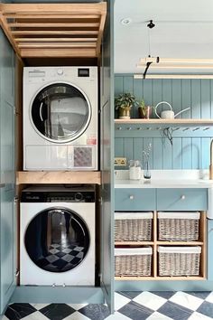 a washer and dryer in a small room with blue walls, checkered flooring and open shelving