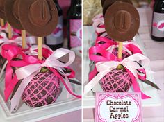 chocolate caramel apples decorated with pink ribbon and brown cowboy hats on top are displayed in front of wine bottles