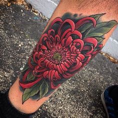 a person with a flower tattoo on their leg