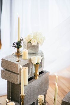 candles and flowers are placed on concrete blocks