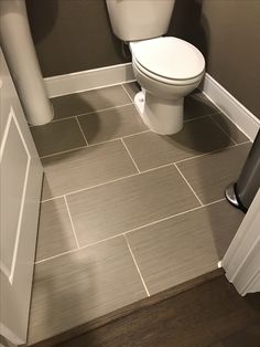 a white toilet sitting in a bathroom next to a radiator