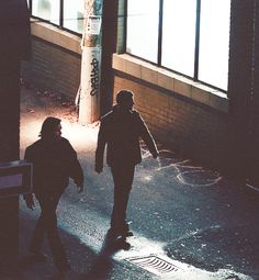 two people walking down the street at night