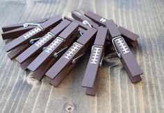 a bunch of wooden clothes pins sitting on top of a wooden table next to each other