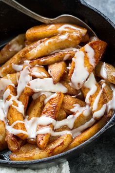 french fries with icing in a cast iron skillet