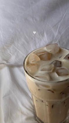 an iced drink is sitting on a white sheet