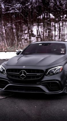 the front end of a black mercedes s - class coupe parked in a parking lot