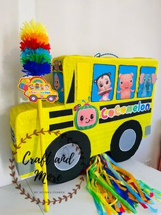 a yellow school bus decorated with pom poms and tissue streamers for decoration