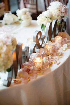 the table is decorated with flowers and candles for an elegant touch to the wedding reception