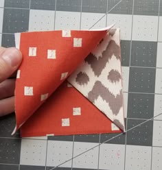 someone is cutting out an origami piece with scissors