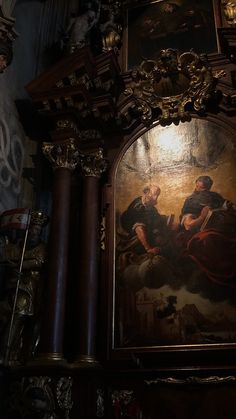 an ornate painting on the side of a wall in a room with many other items