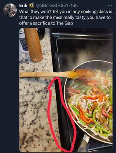 a wok filled with vegetables on top of a stove